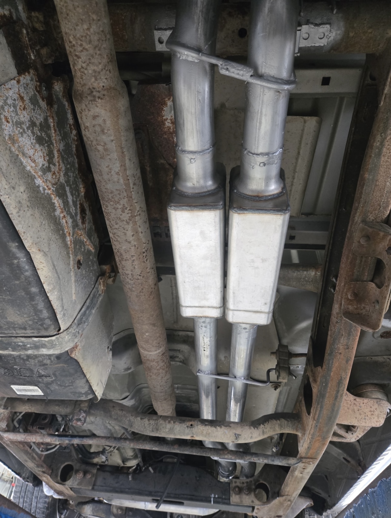 Dual muffler installation on a truck underside