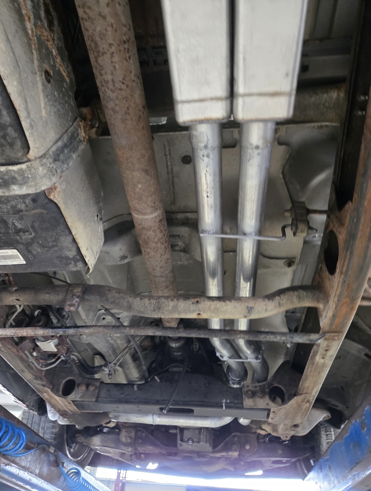 Exhaust pipes and mufflers on a truck underside