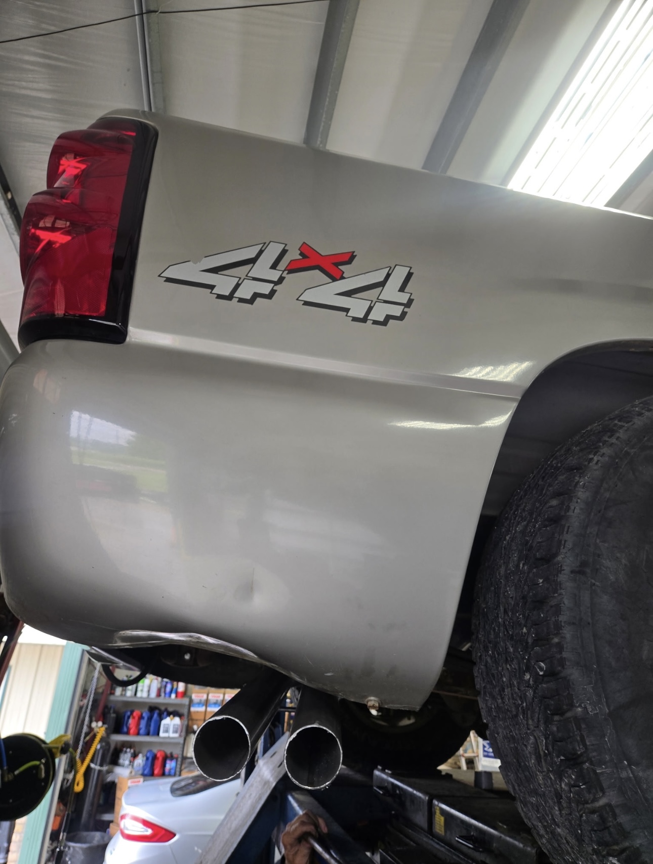 4x4 truck in the shop bay with dual exhaust tips