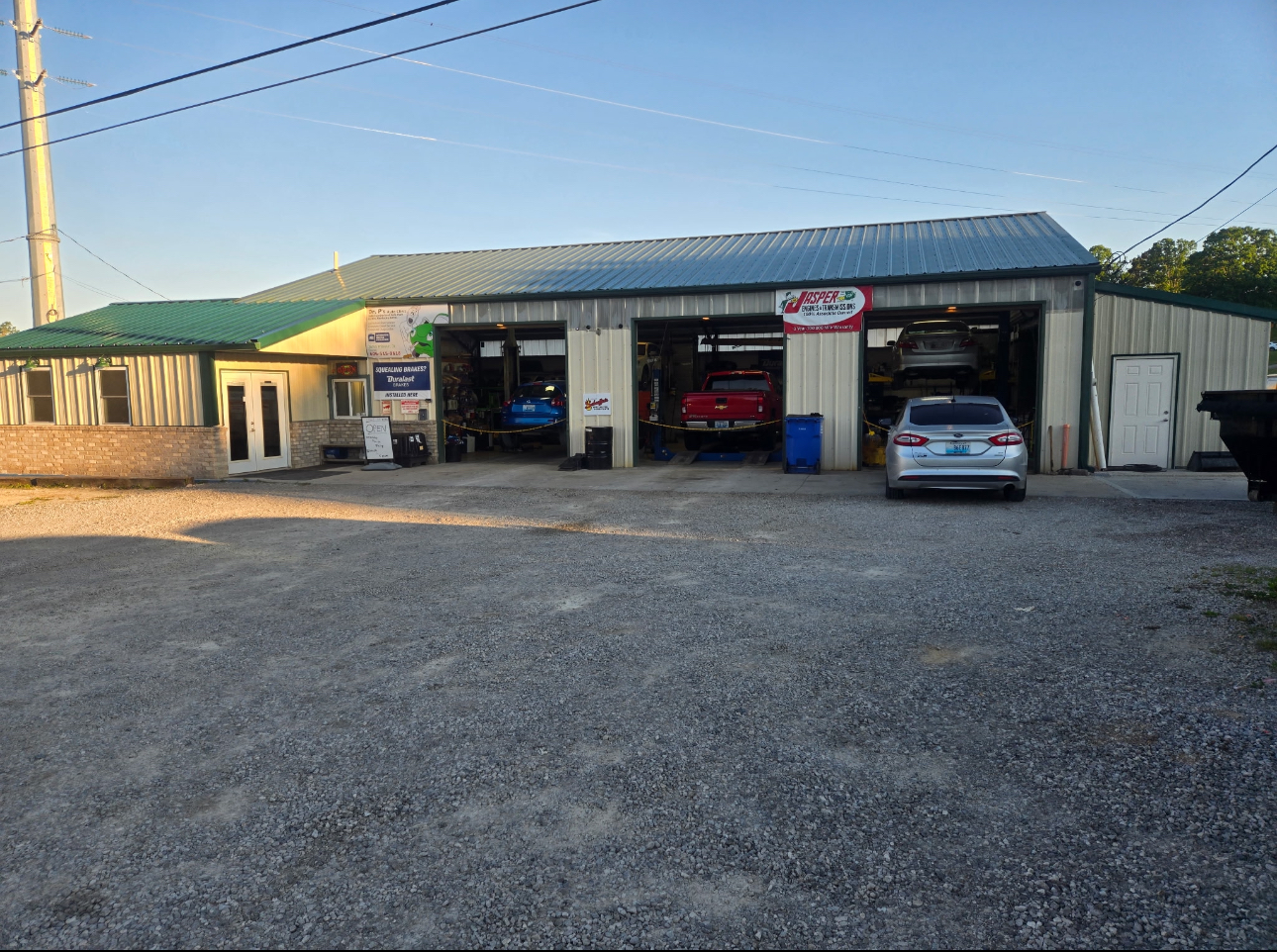 Dr. P's Auto Clinic exterior with vehicles in the service bays