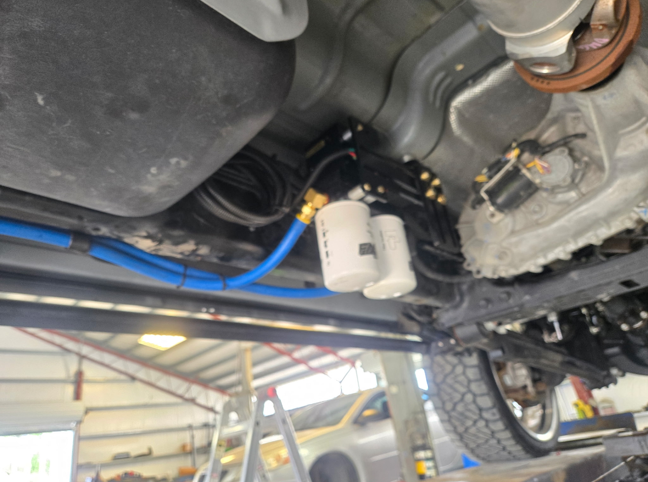 Dual fuel filters on a diesel truck underside during service
